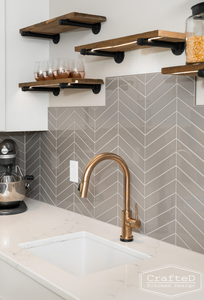 gold delta trinsic faucet in pantry kitchen with floating shelves