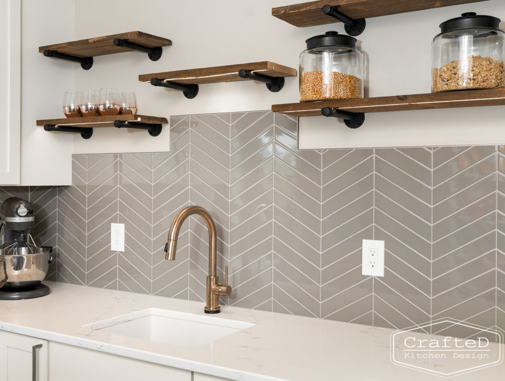 gold delta trinsic faucet in pantry kitchen with floating shelves