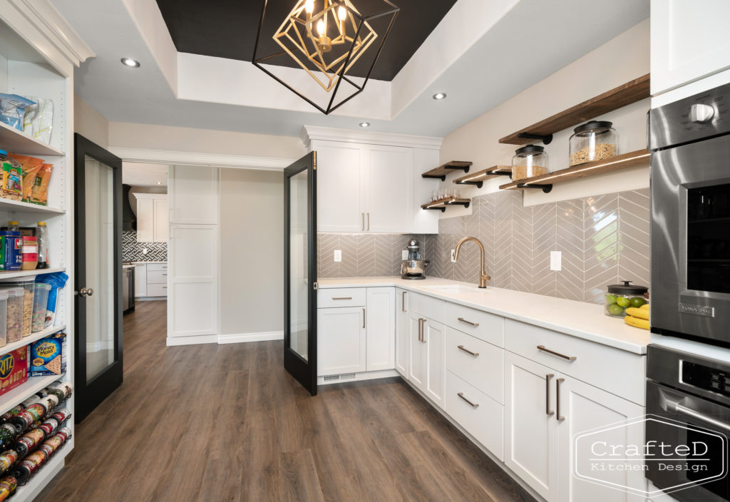 gold delta trinsic faucet in pantry kitchen with floating shelves black and gold light