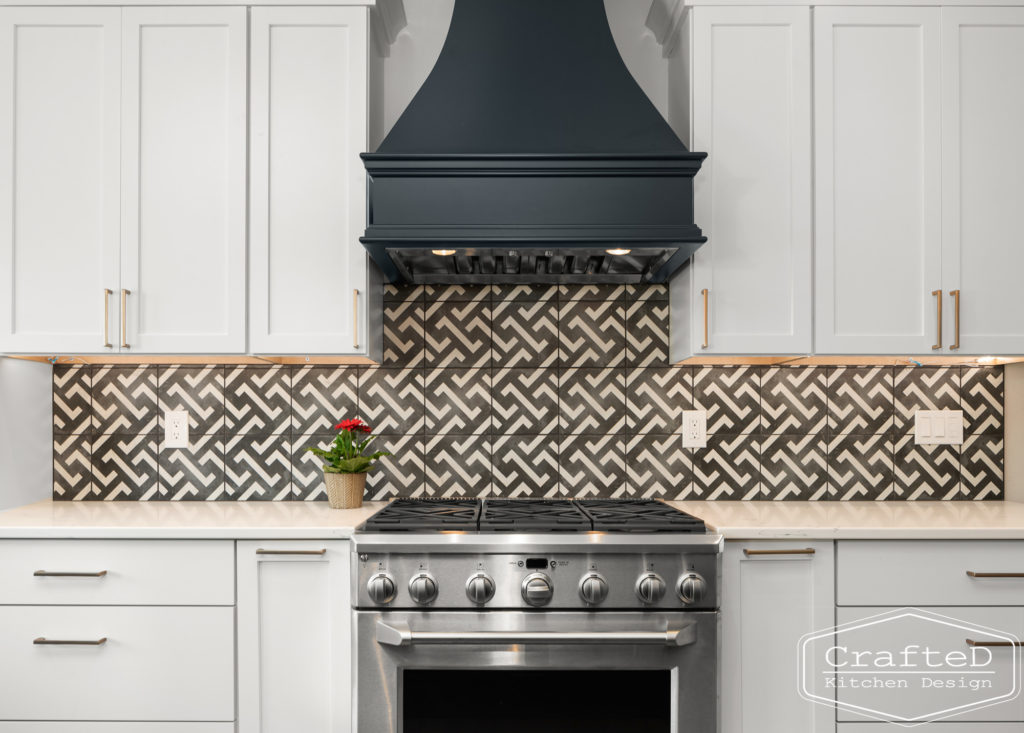 spokane kitchen design with black and white patterned tile and black hood white cabinets