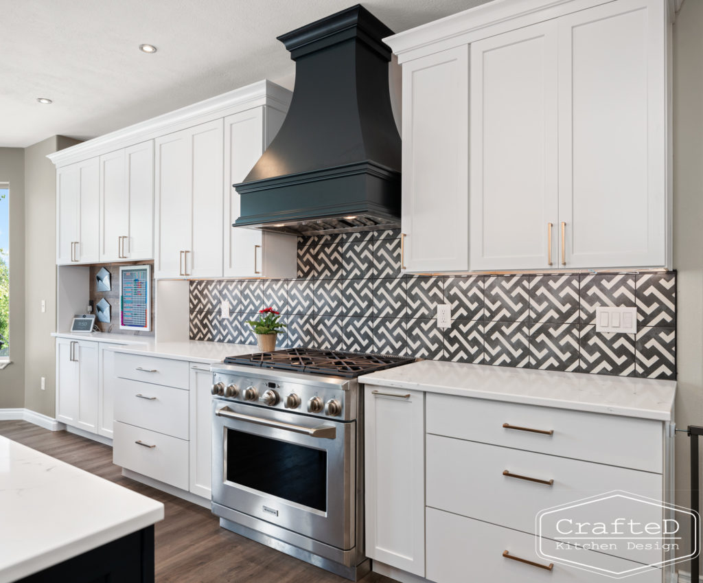 spokane kitchen design with white cabinets black hood and patterned tile