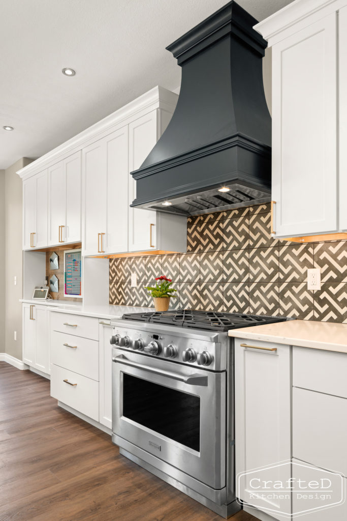 spokane kitchen design with white cabinets black hood and patterned tile