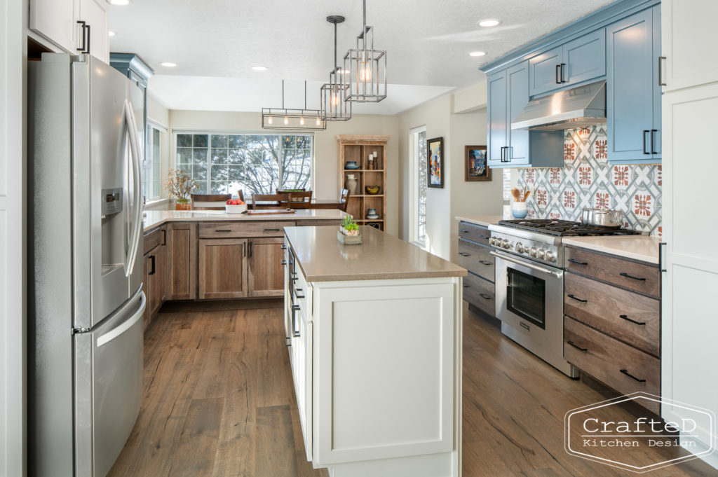 Multi colored kitchen design with blue white warm wood and patterned tile