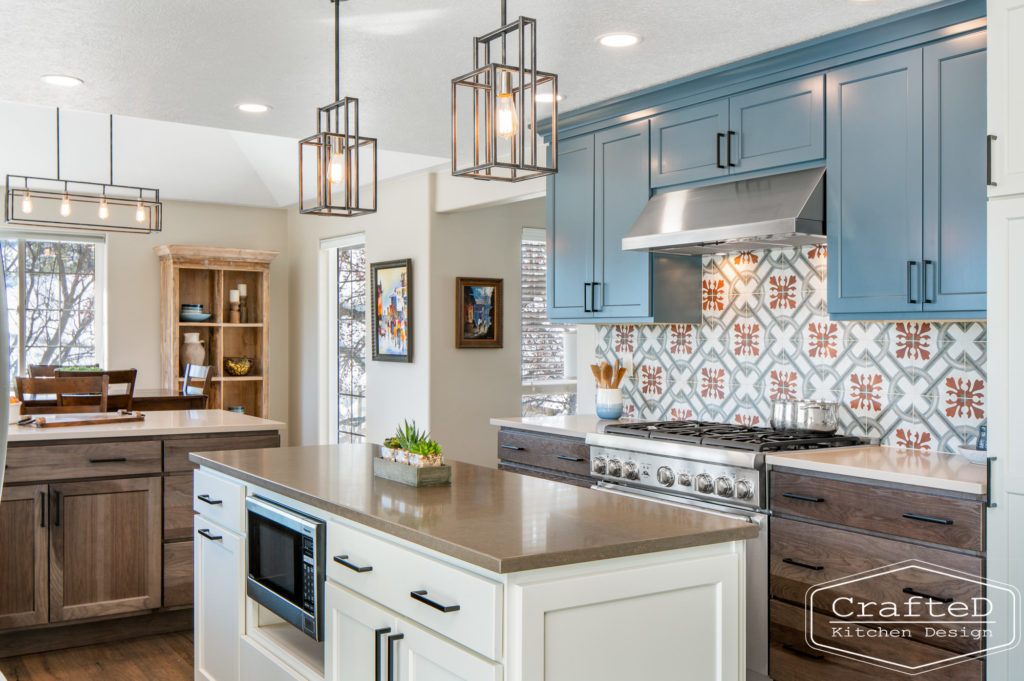 Multi colored kitchen design with blue white warm wood and patterned tile
