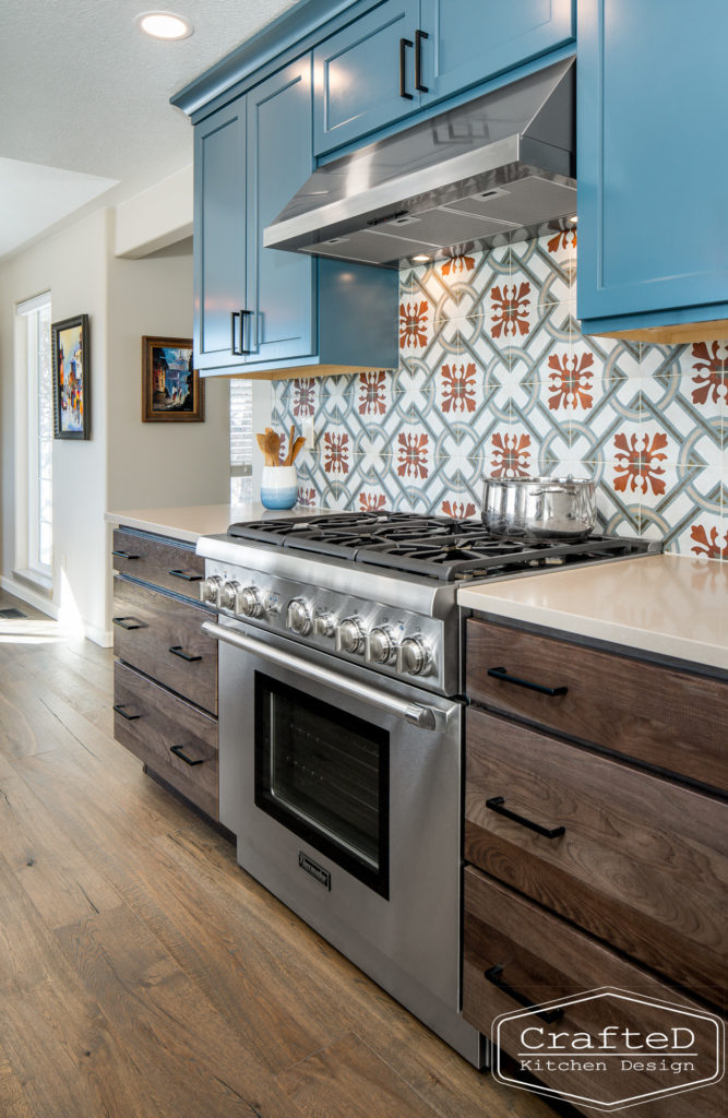 Multi colored kitchen design with blue white warm wood and patterned tile