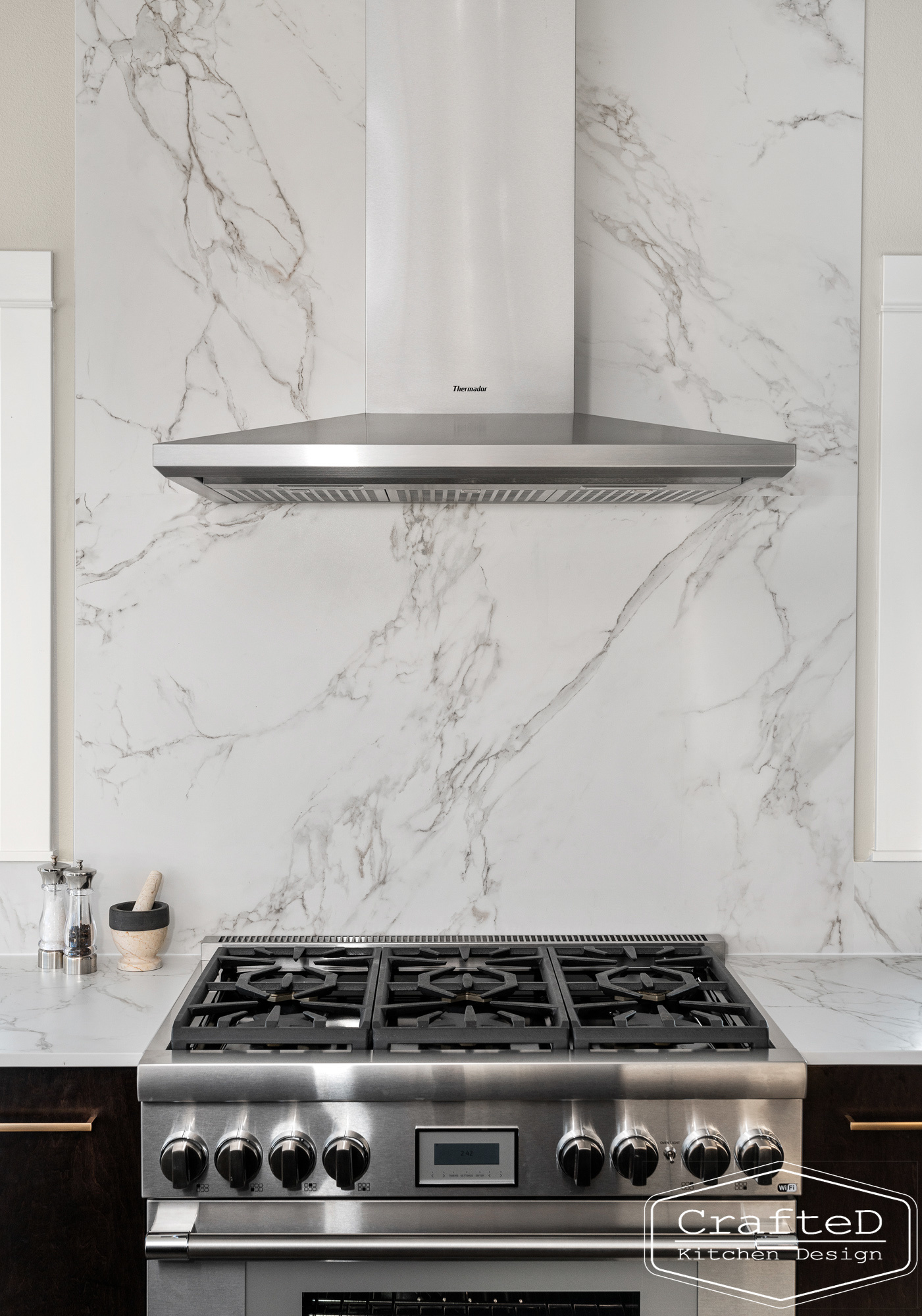 modern metropolitan kitchen design with dark toned wood cabinets, dekton marble backsplash and gold accents in spokane Coeur d'alene moses lake home renovation