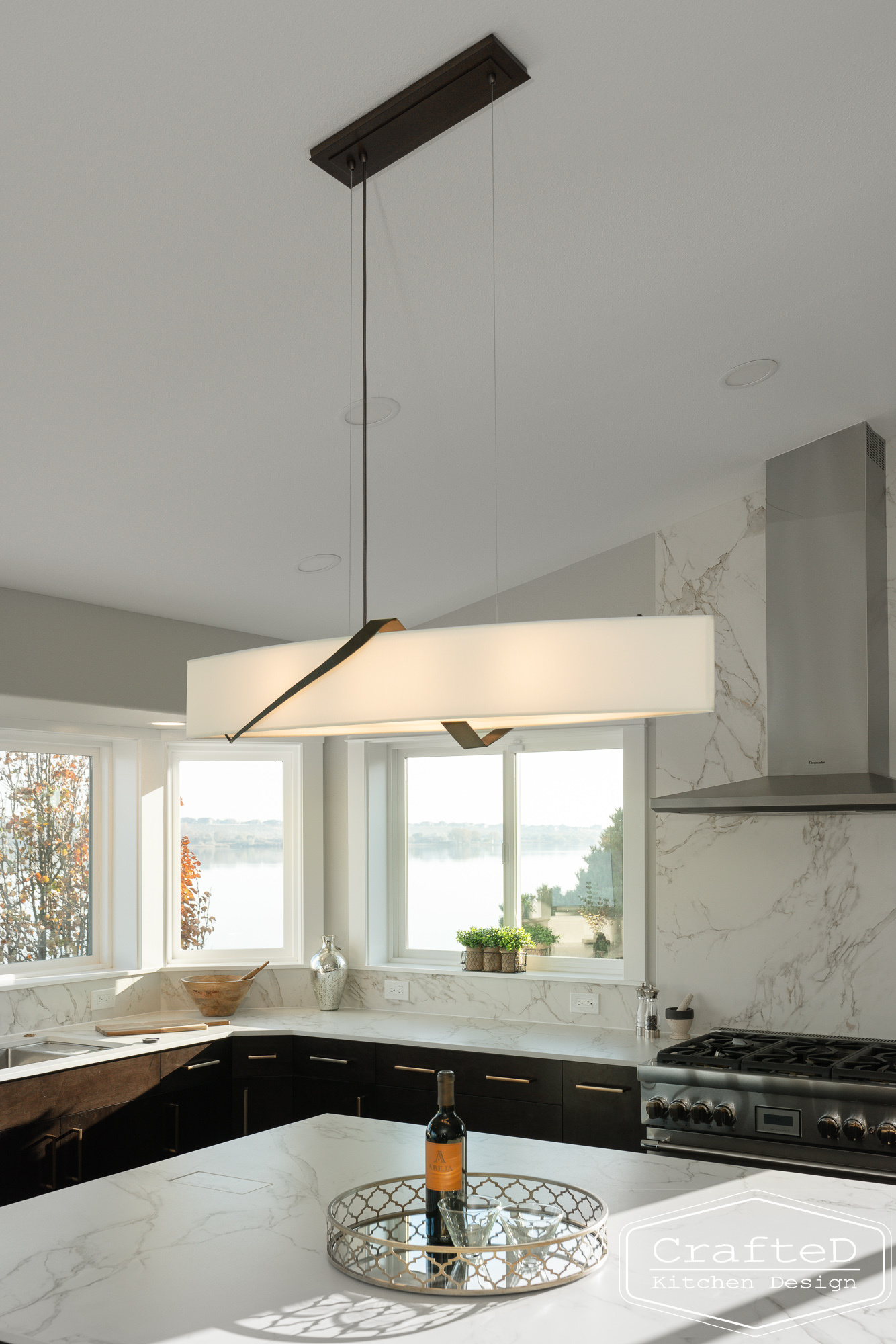 modern metropolitan kitchen design with dark toned wood cabinets, dekton marble backsplash and gold accents in spokane Coeur d'alene moses lake home renovation