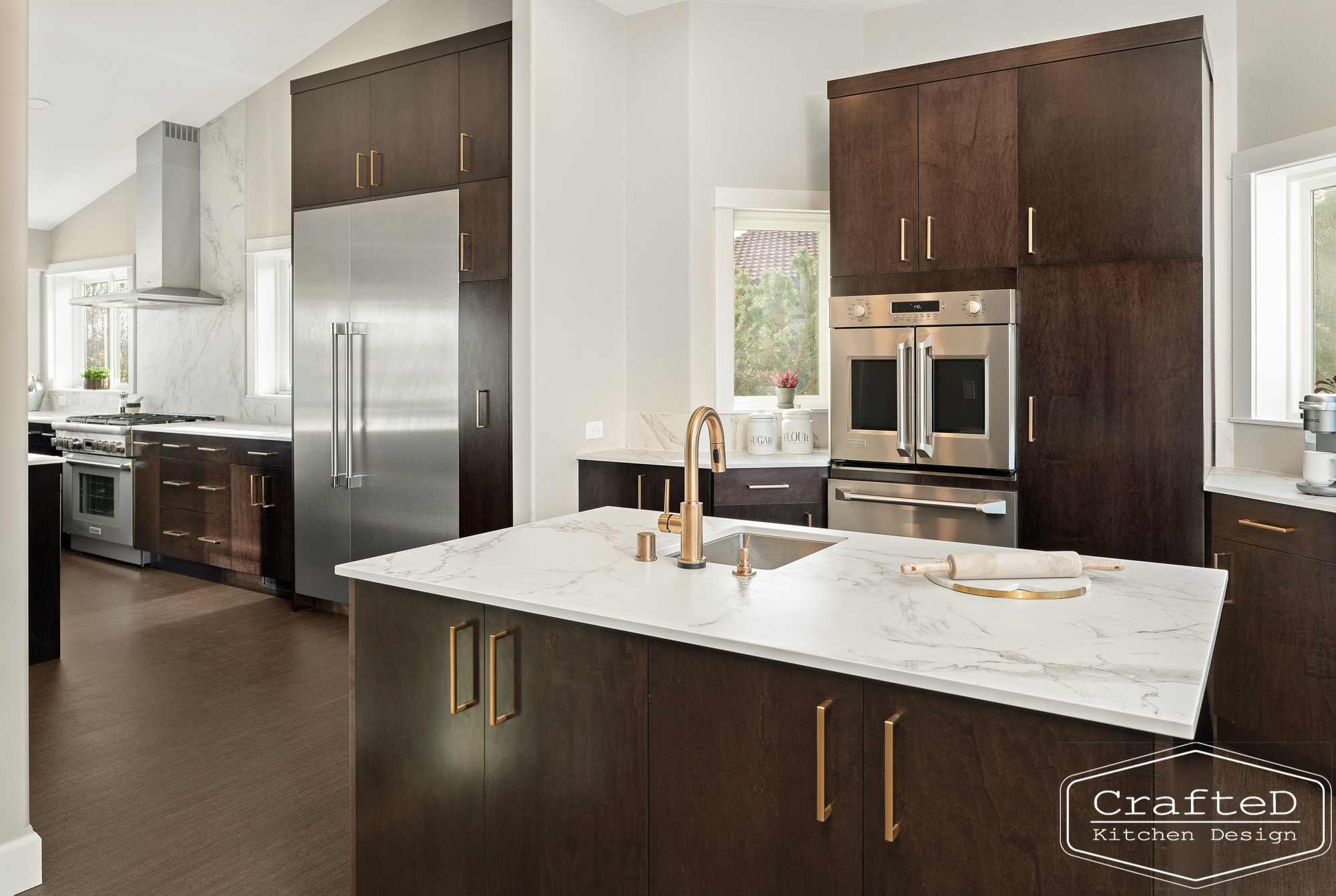 modern metropolitan kitchen design with dark toned wood cabinets, dekton marble backsplash and gold accents in spokane Coeur d'alene moses lake home renovation