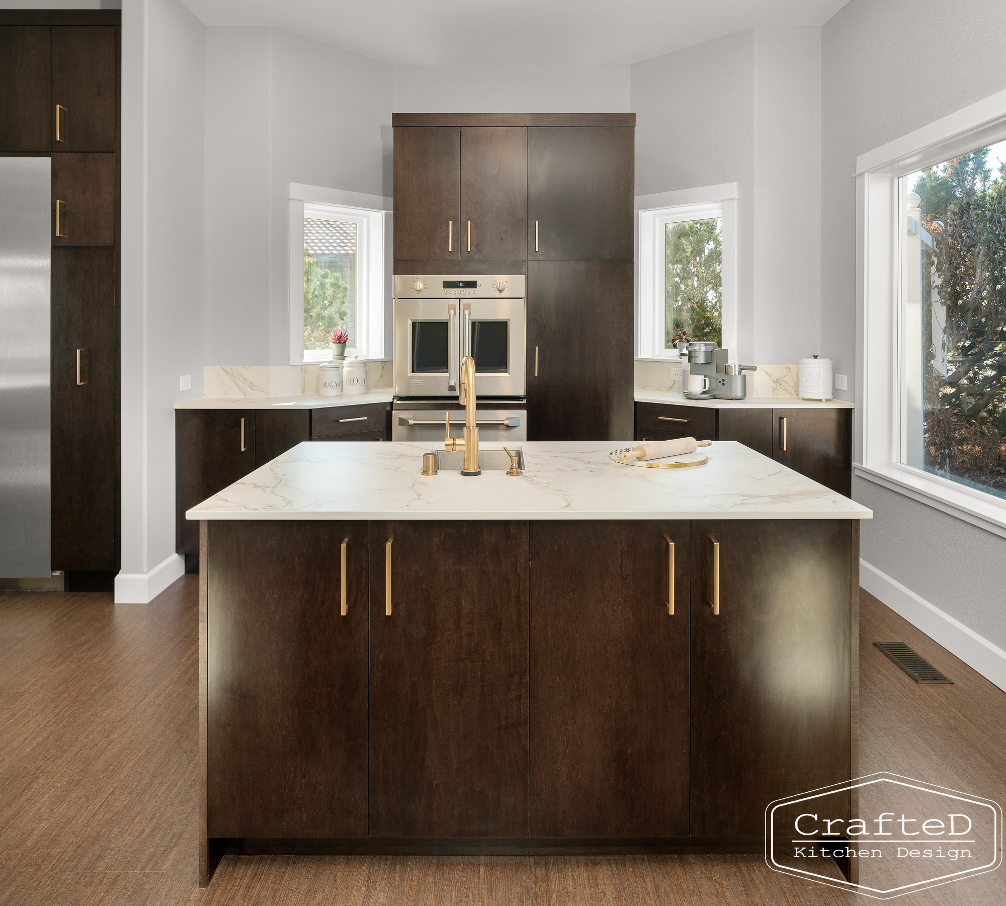 modern metropolitan kitchen design with dark toned wood cabinets, dekton marble backsplash and gold accents in spokane Coeur d'alene moses lake home renovation