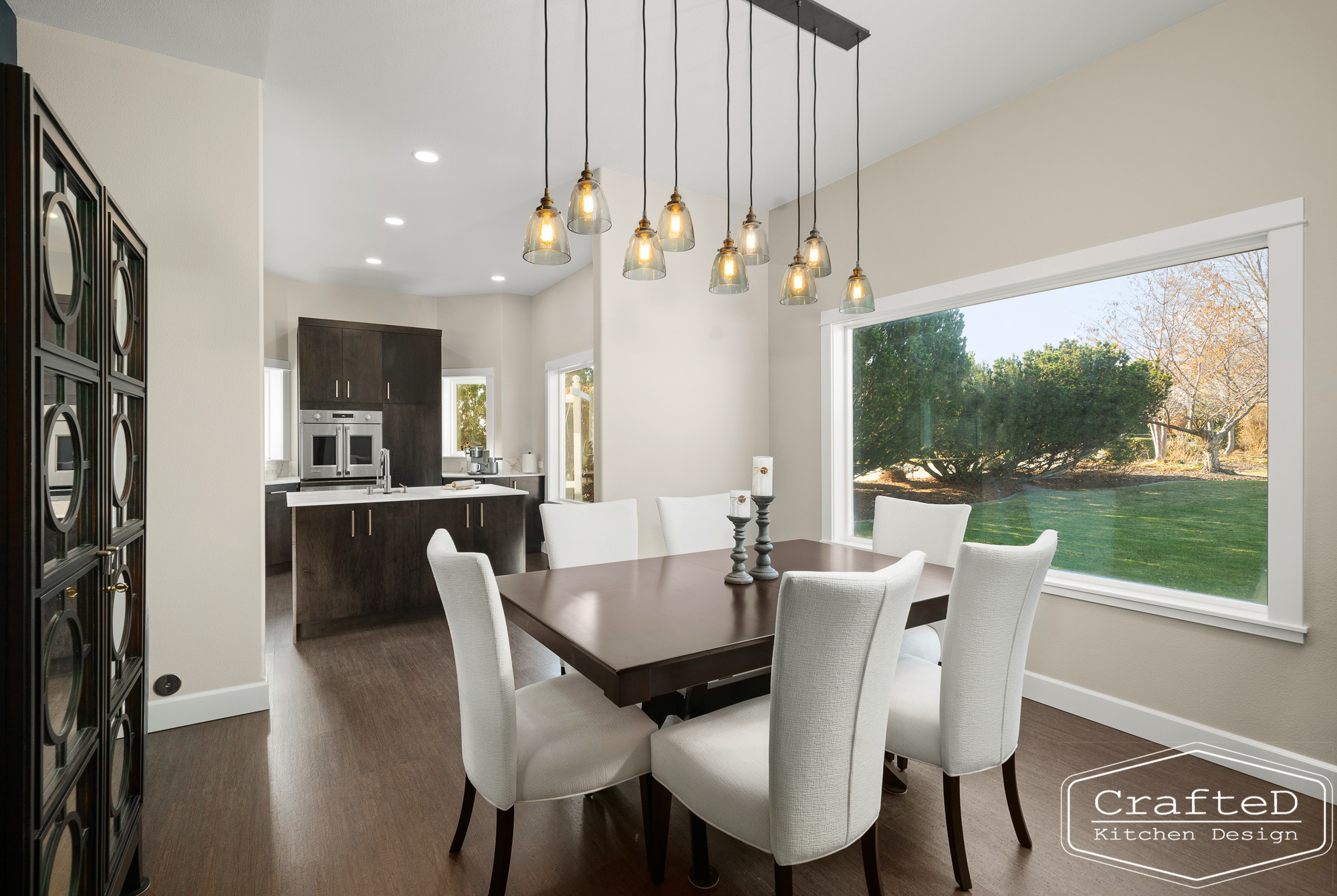 modern metropolitan kitchen design with dark toned wood cabinets, dekton marble backsplash and gold accents in spokane Coeur d'alene moses lake home renovation