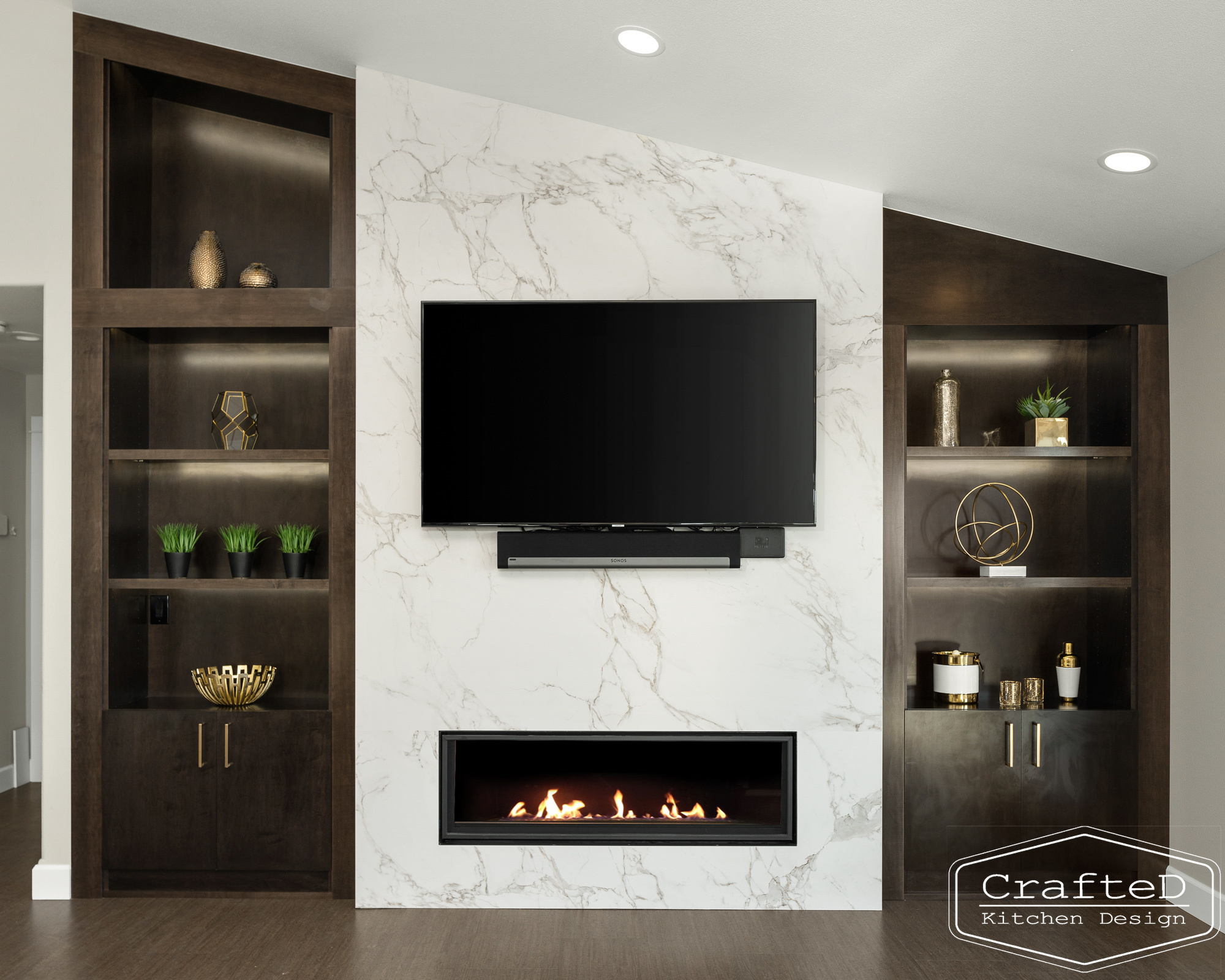 modern metropolitan fireplace design with dark toned wood cabinets, dekton marble backsplash and gold accents in spokane Coeur d'alene moses lake home renovation