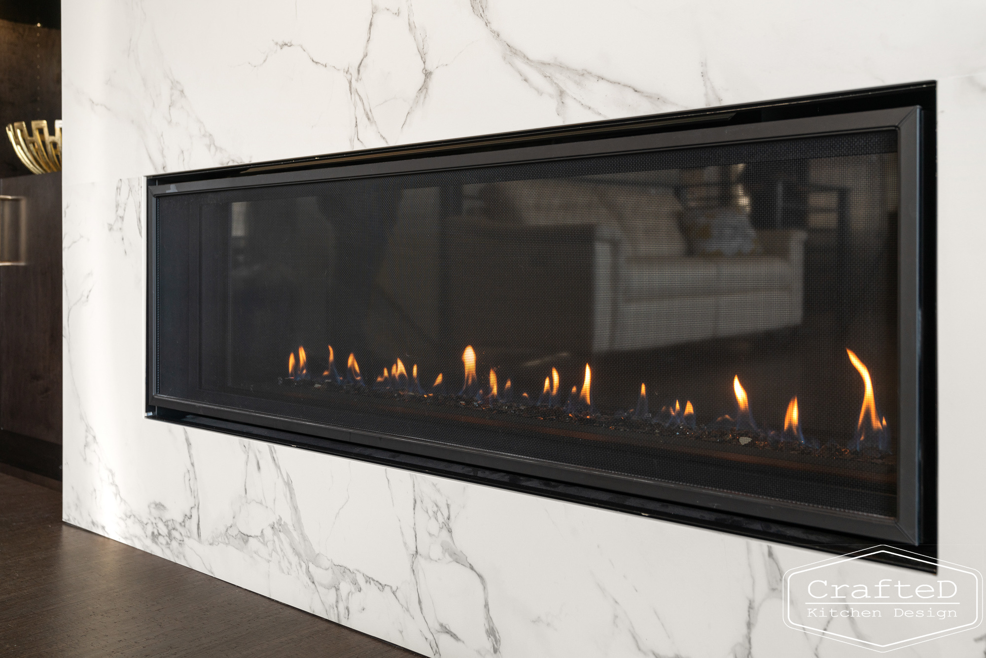 modern metropolitan fireplace design with dark toned wood cabinets, dekton marble backsplash and gold accents in spokane Coeur d'alene moses lake home renovation