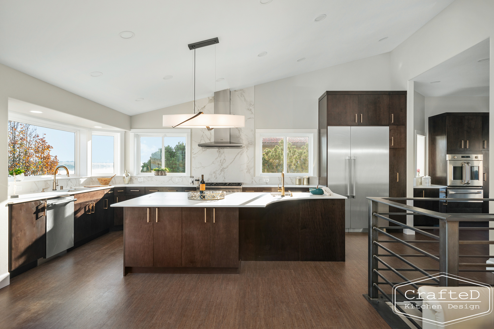 modern metropolitan kitchen design with dark toned wood cabinets, dekton marble backsplash and gold accents in spokane Coeur d'alene moses lake home renovation