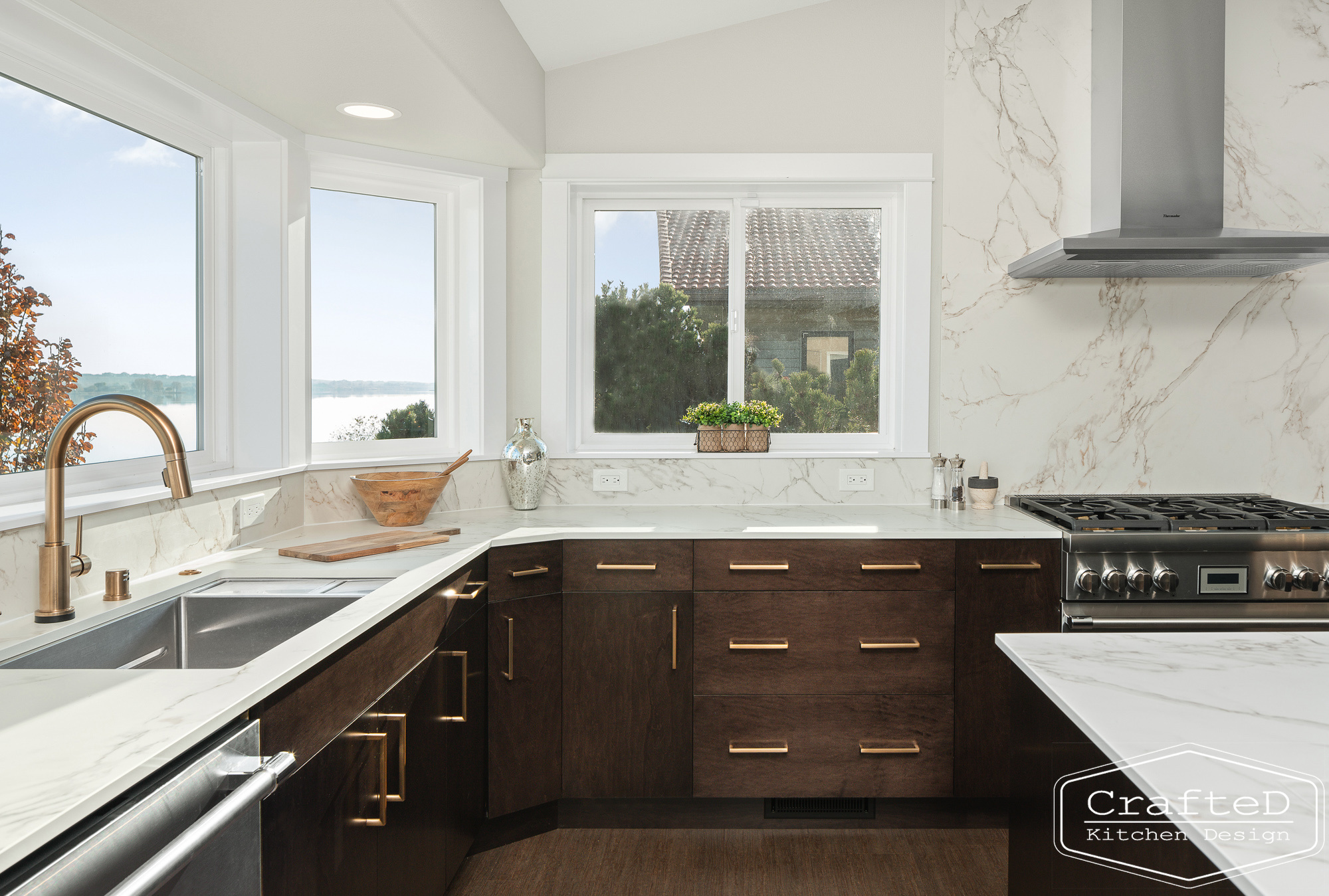 modern metropolitan kitchen design with dark toned wood cabinets, dekton marble backsplash and gold accents in spokane Coeur d'alene moses lake home renovation