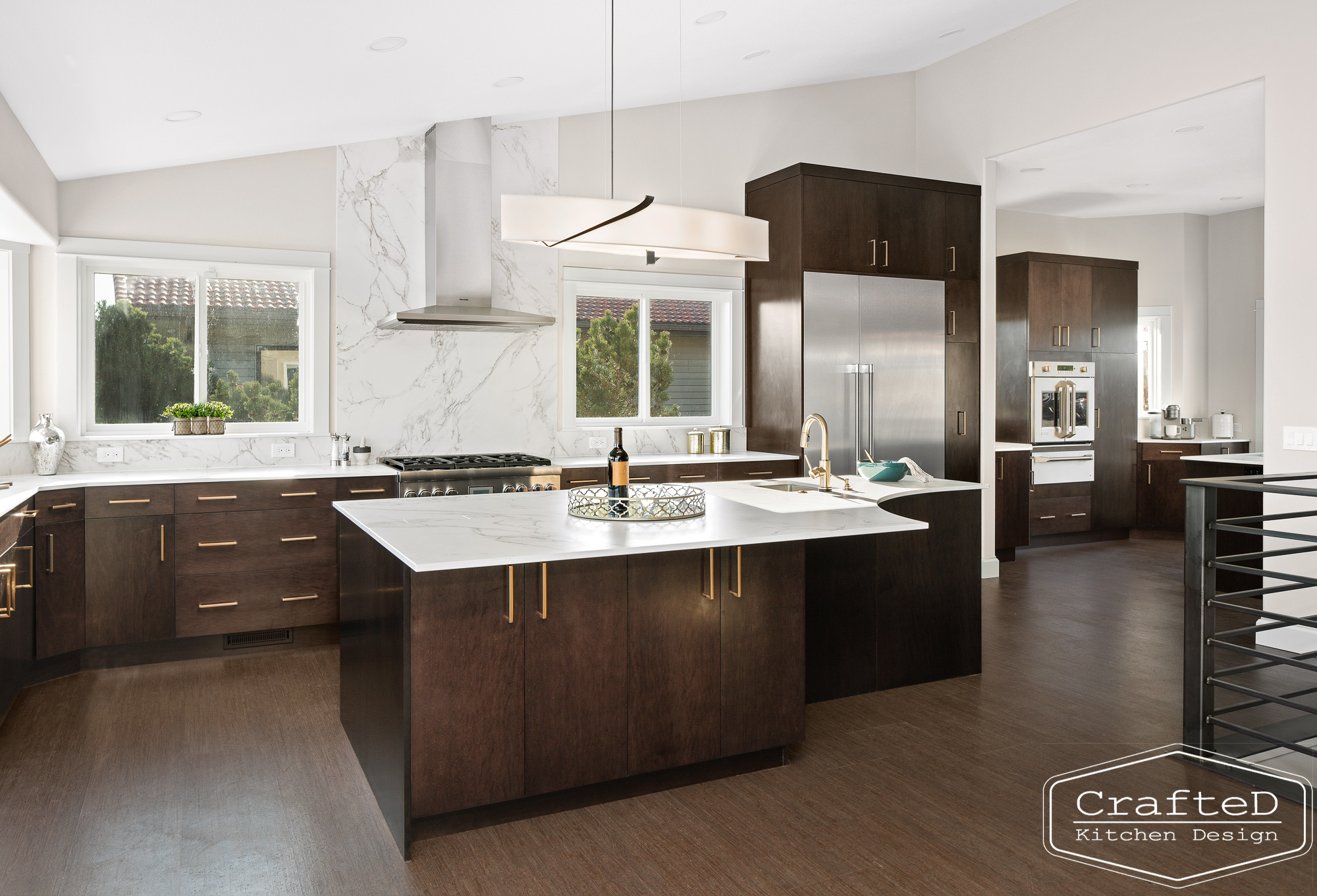 modern metropolitan kitchen design with dark toned wood cabinets, dekton marble backsplash and gold accents in spokane Coeur d'alene moses lake home renovation