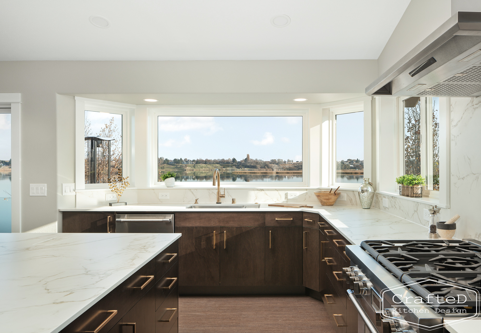 modern metropolitan kitchen design with dark toned wood cabinets, dekton marble backsplash and gold accents in spokane Coeur d'alene moses lake home renovation