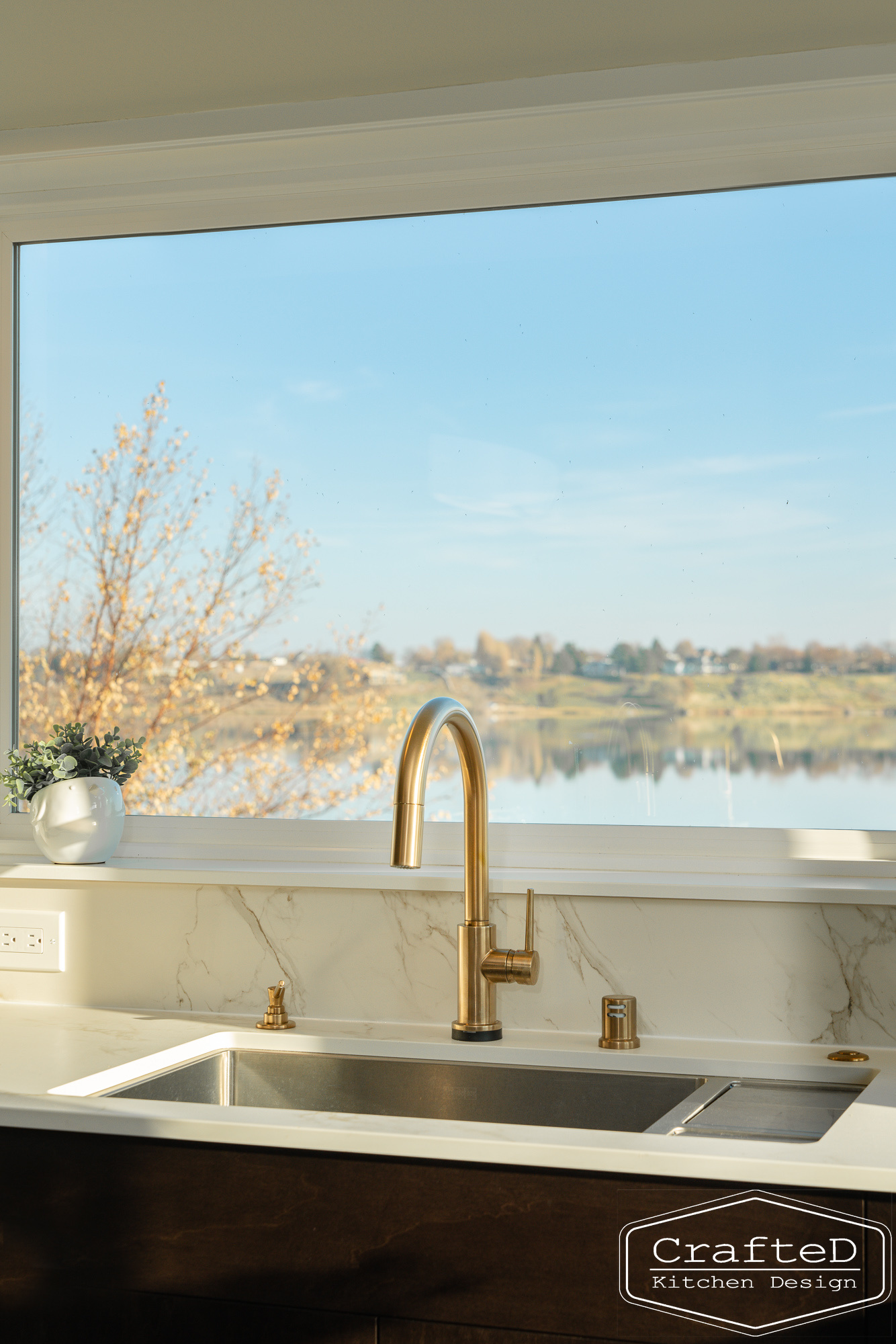 modern metropolitan kitchen design with dark toned wood cabinets, dekton marble backsplash and gold accents in spokane Coeur d'alene moses lake home renovation with amazing views