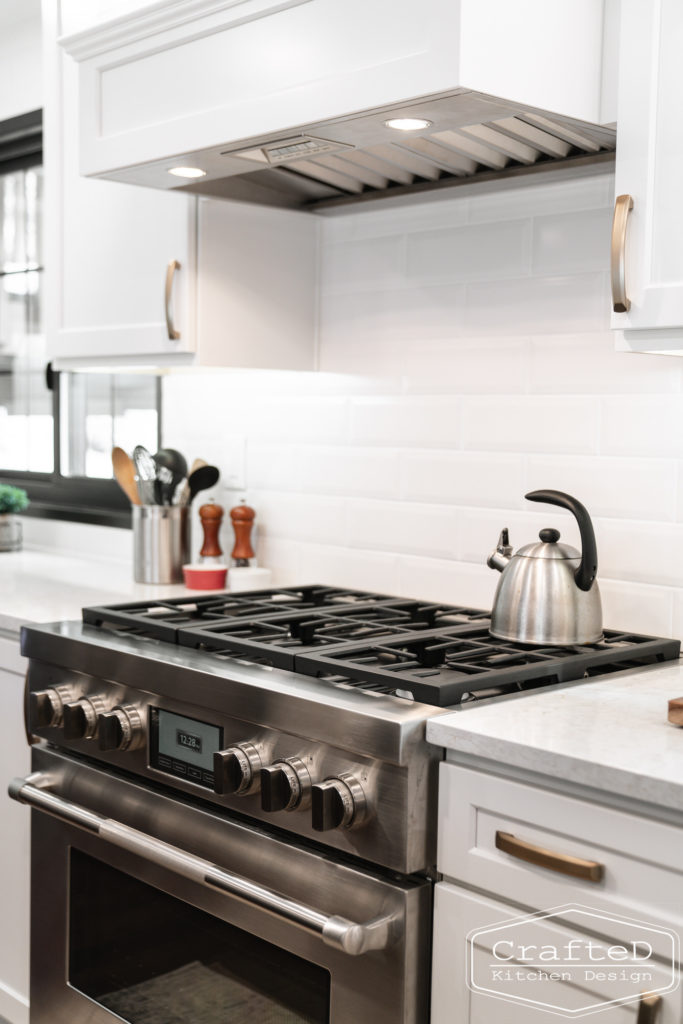 Large kitchen inspiration for split level home renovation, black and white and brown kitchen cabinets with black accents and gold hardware