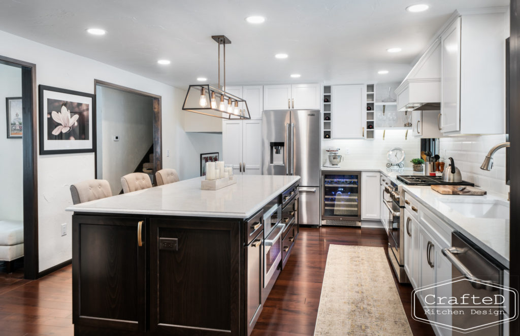 Large kitchen inspiration for split level home renovation, black and white and brown kitchen cabinets with gold hardware