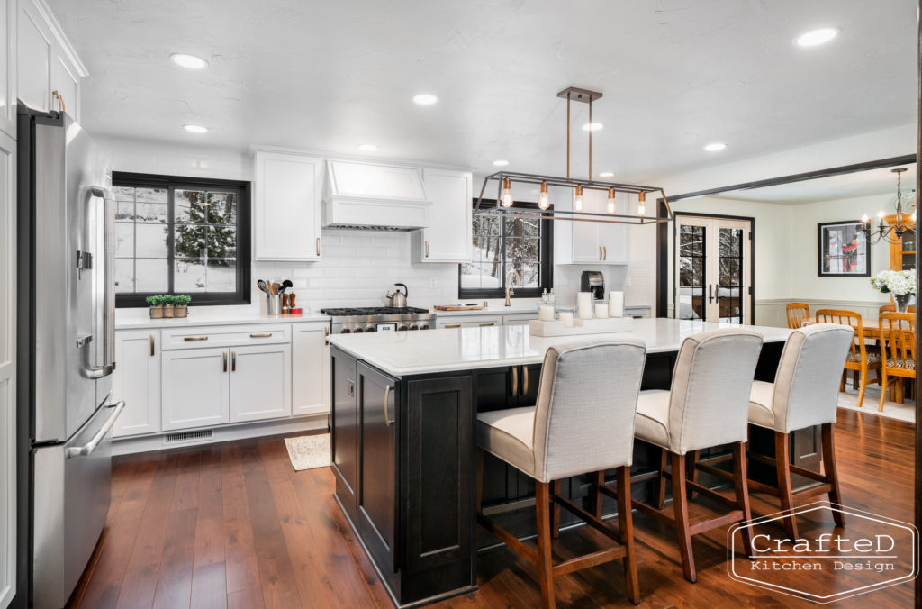 Large kitchen inspiration for split level home renovation, black and white and brown kitchen cabinets with gold hardware