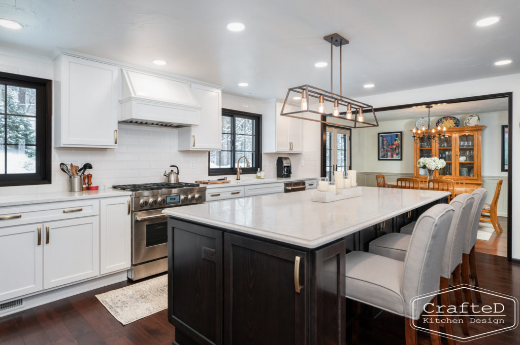 Large kitchen inspiration for split level home renovation, black and white and brown kitchen cabinets with gold hardware