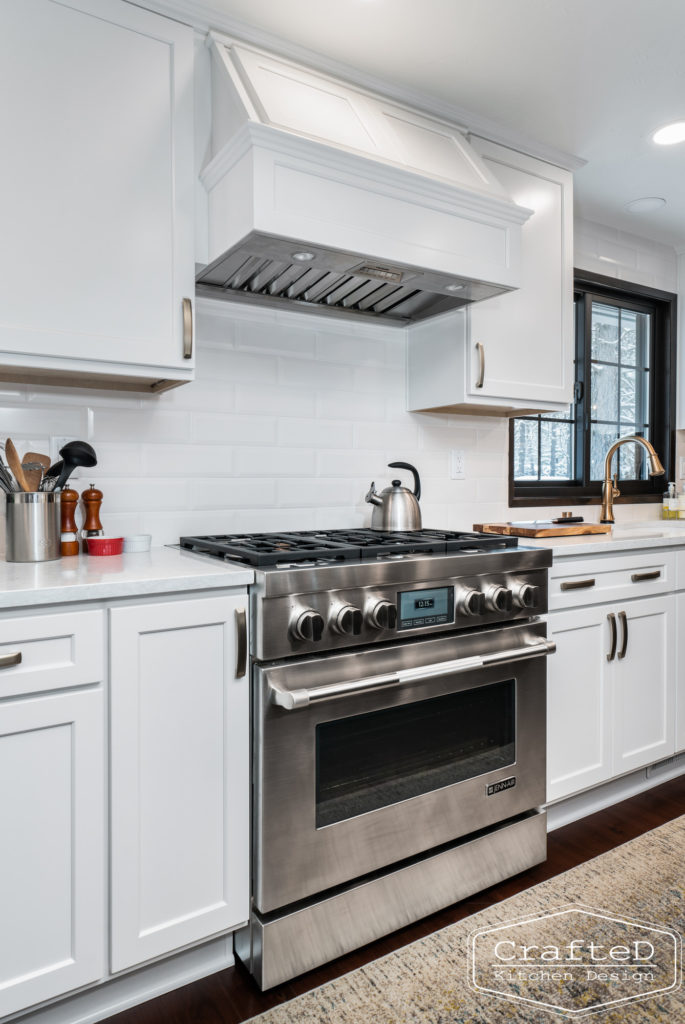 Large kitchen inspiration for split level home renovation, black and white and brown kitchen cabinets with gold hardware