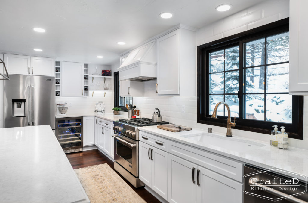 Large kitchen inspiration for split level home renovation, black and white and brown kitchen cabinets with black accents and gold hardware