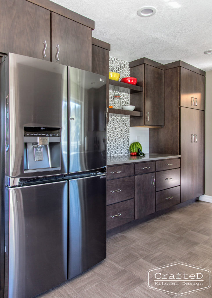 dark wood kitchen cabinets with lvp flooring and penny tile backsplash design