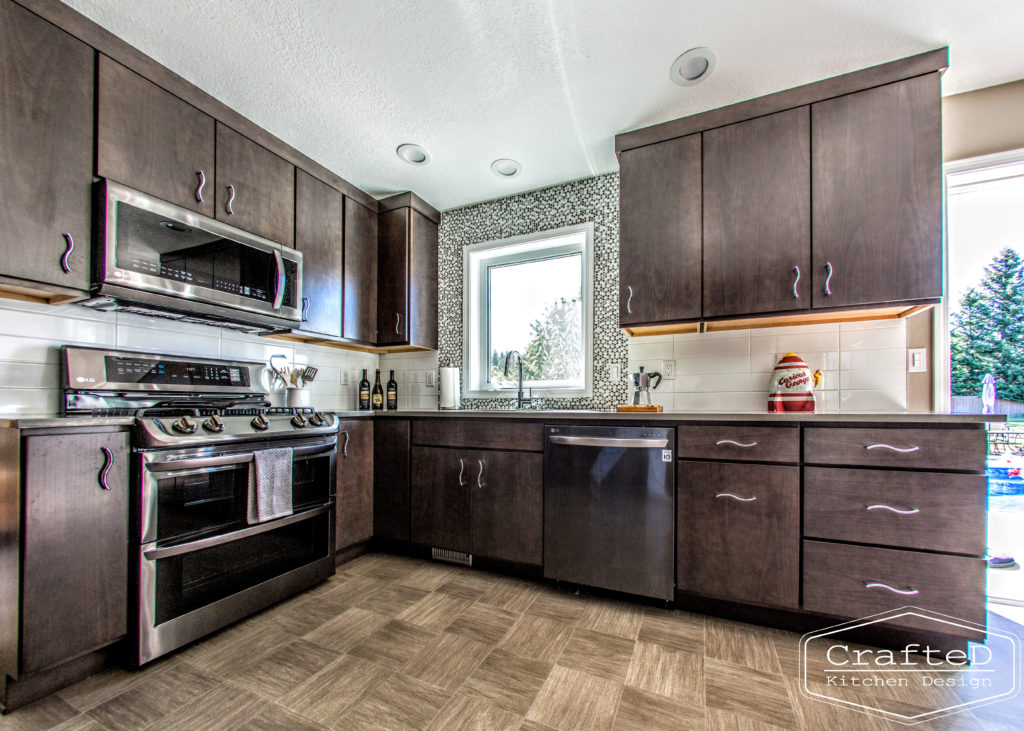 dark wood kitchen cabinets with lvp flooring and penny tile backsplash design