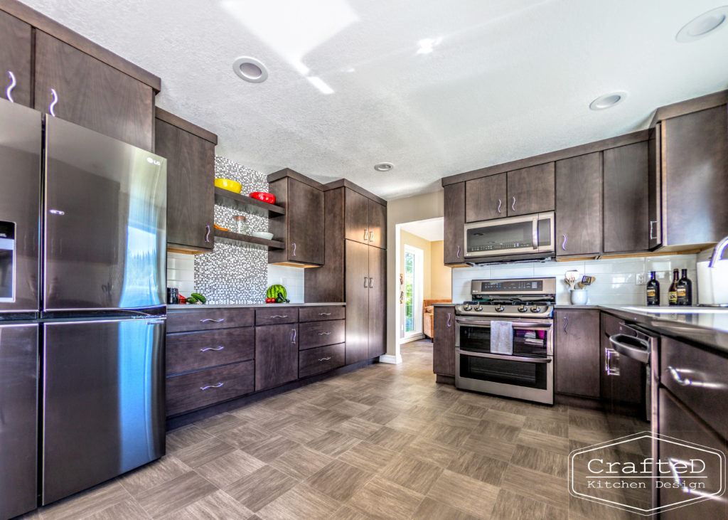 dark wood kitchen cabinets with lvp flooring and penny tile backsplash design