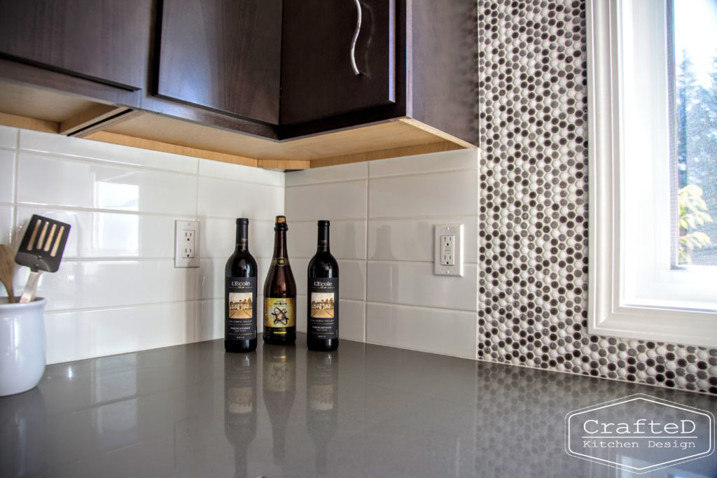 dark wood kitchen cabinets with lvp flooring and penny tile backsplash design