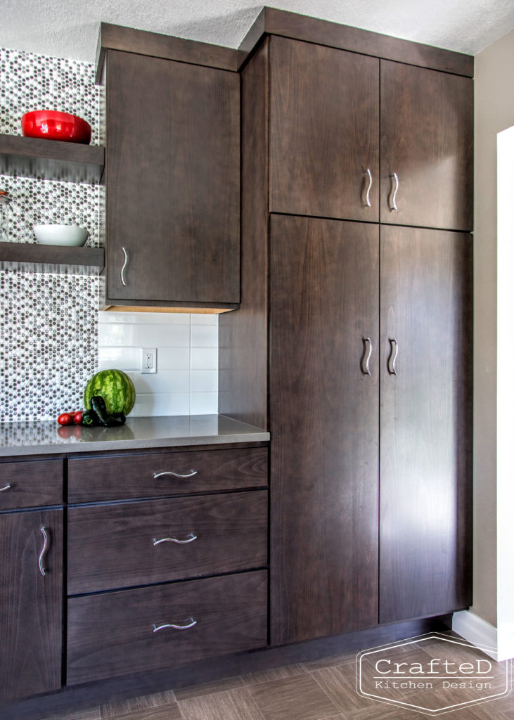 dark wood kitchen cabinets with lvp flooring and penny tile backsplash design