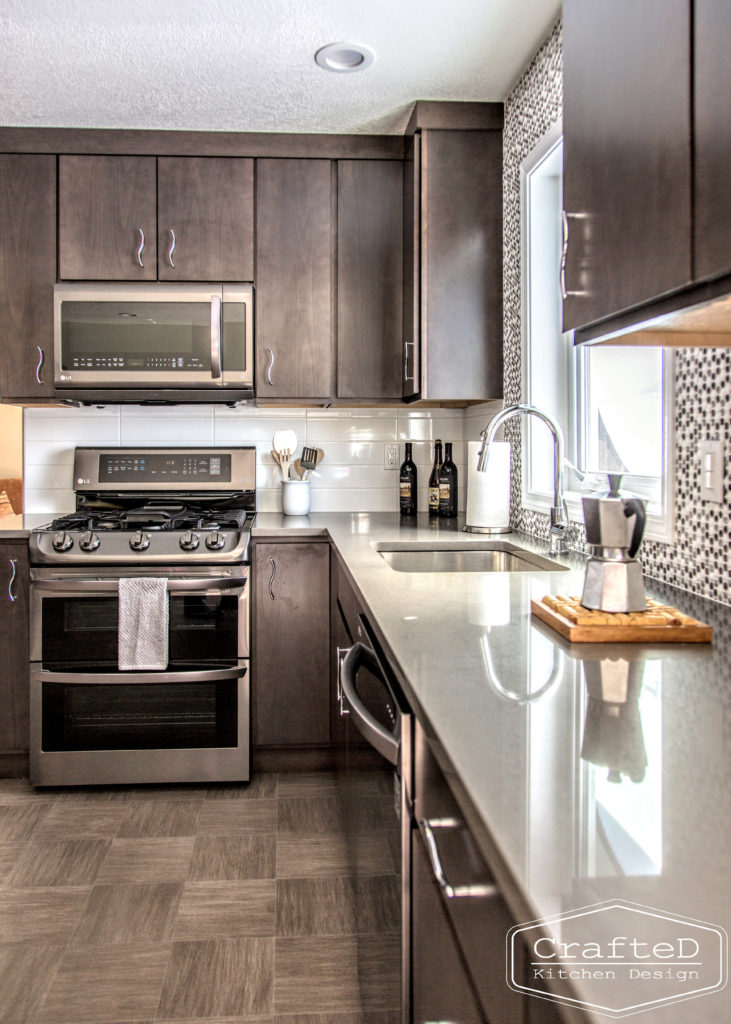 dark wood kitchen cabinets with lvp flooring and penny tile backsplash design