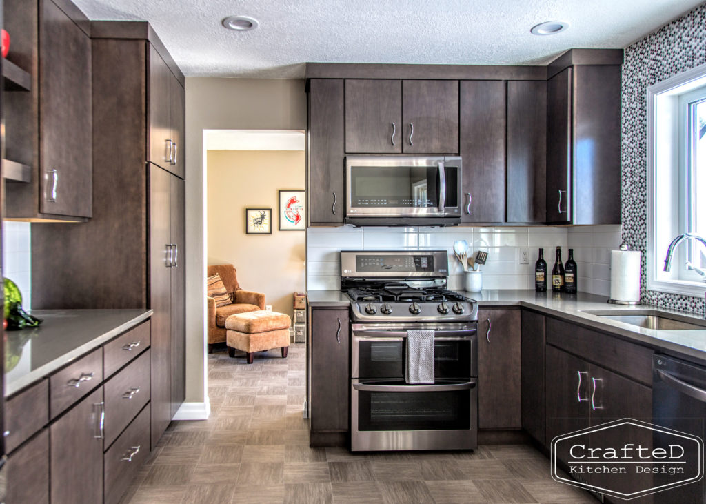 dark wood kitchen cabinets with lvp flooring and penny tile backsplash design