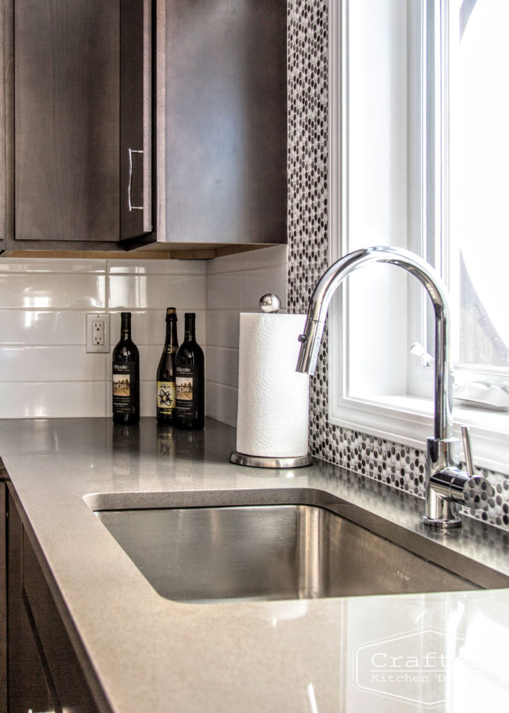 dark wood kitchen cabinets with lvp flooring and penny tile backsplash design