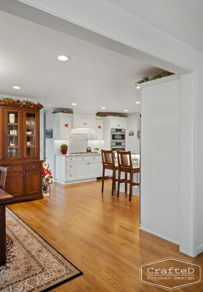 traditional white kitchen with island and coffee bar station and wine bar and built in hutch