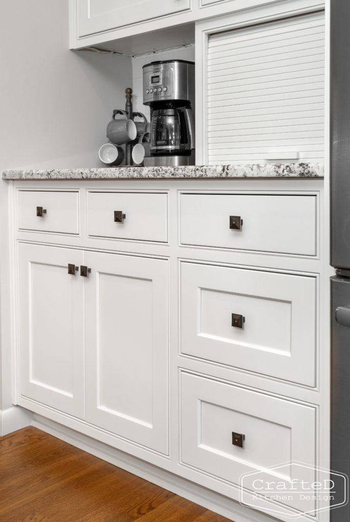 traditional white kitchen with island and coffee bar station and wine bar and built in hutch