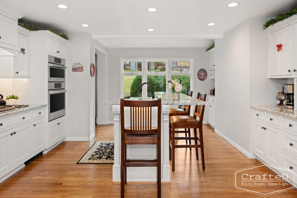 traditional white kitchen with island and coffee bar station and wine bar and built in hutch