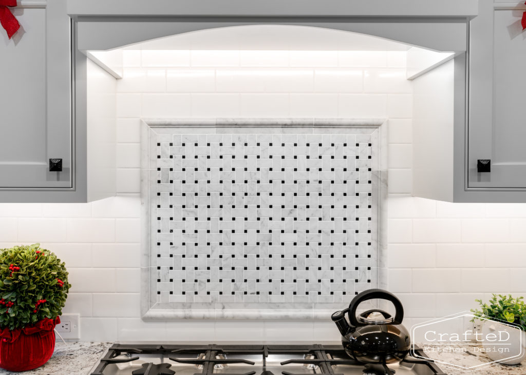 black and white marble kitchen range tile accent above range
