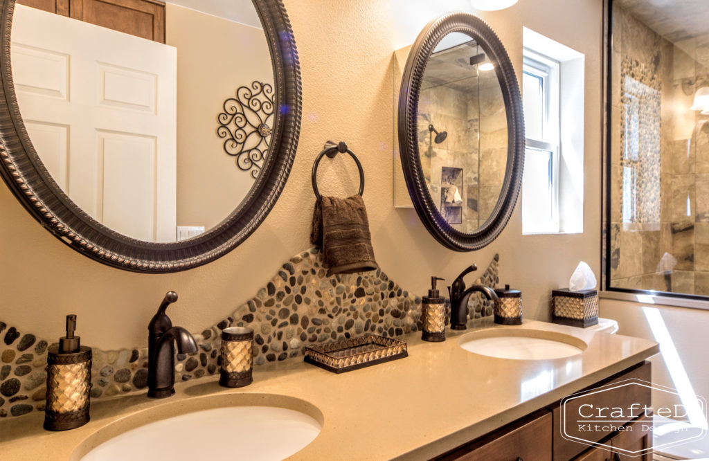 pebblies inspired bathroom remodel with wood cabinets and warm accent tile