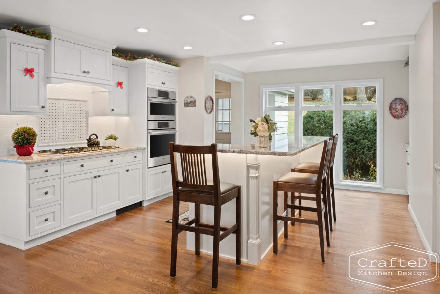 traditional white kitchen with island and coffee bar station and wine bar and built in hutch